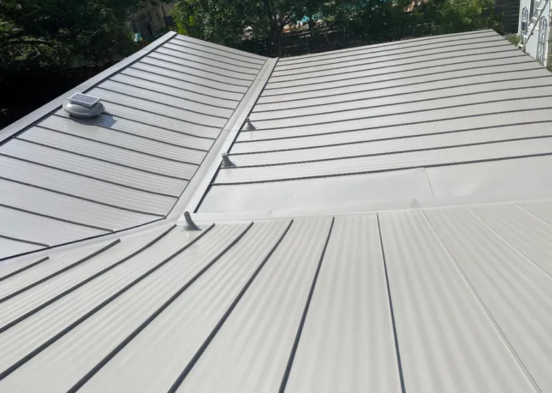 Solar attic fan installed on a metal roof for Roof Ventilation in Lockhart